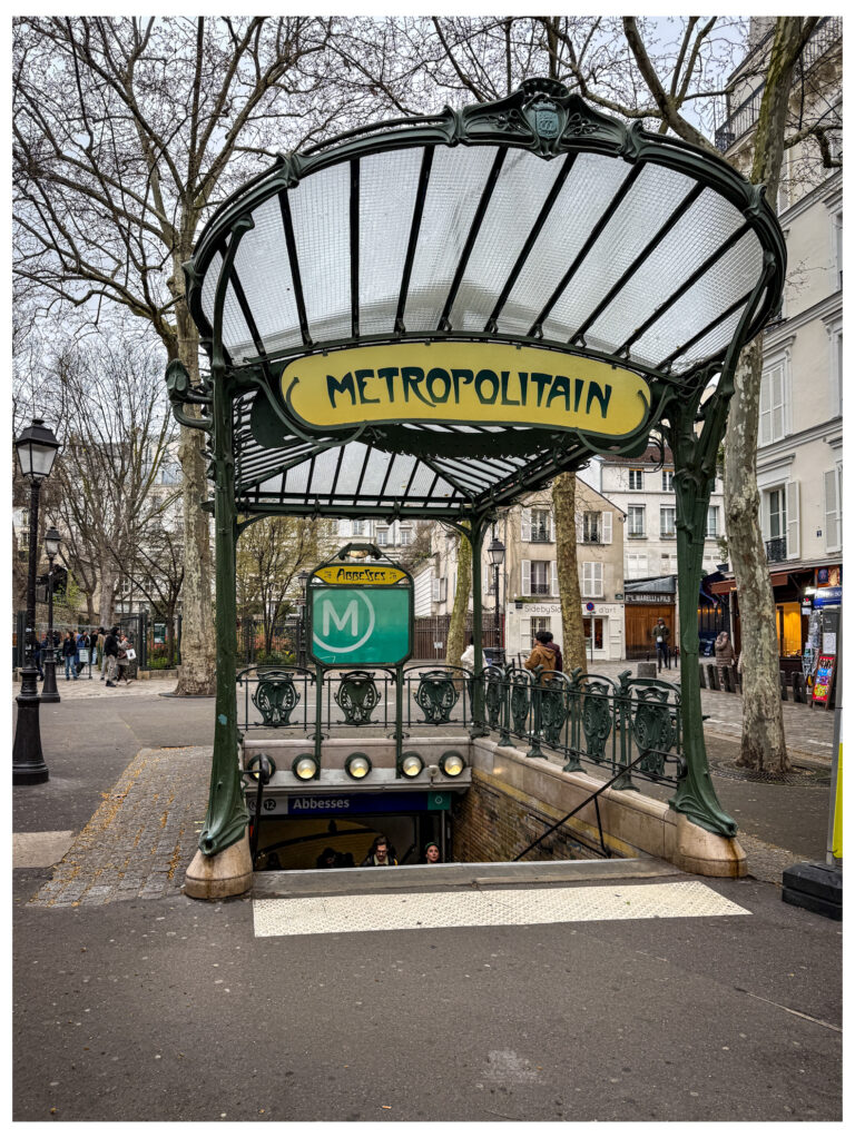 Hectar Guimard's Metropolitain entrance at Metro Line 12 - Abbesses. Cast in wrought-iron with plant adornments, it is one of the few surviving originals.